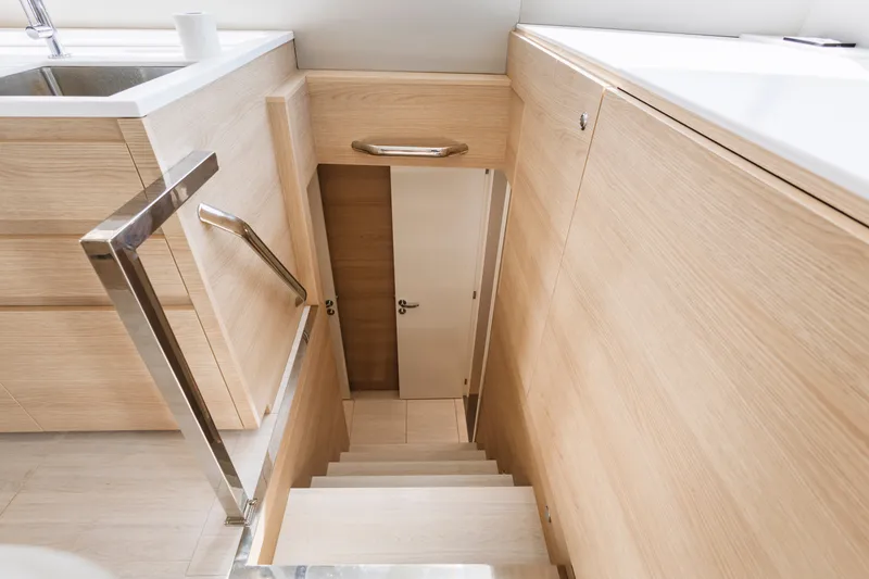 Slide: The Image of Staircase leading to lower deck on 2026 Aventura 56 Motor Yacht, featuring sleek wooden design. - 19