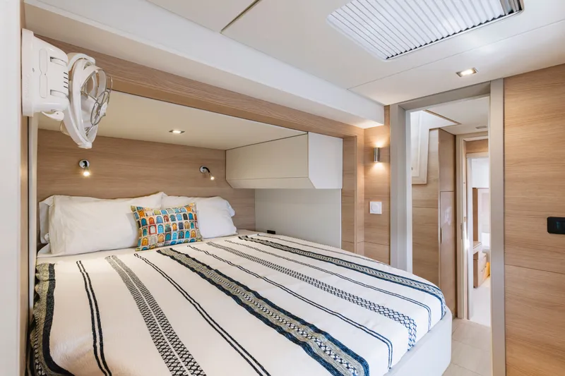 Slide: The Image of Luxurious bedroom interior of 2026 Aventura 56 Motor Yacht with modern design and cozy bedding. - 24
