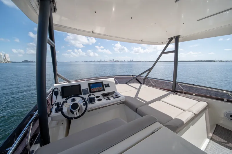 Slide: The Image of Luxurious 2020 Prestige 520 yacht helm with panoramic ocean view and modern navigation equipment. - 32