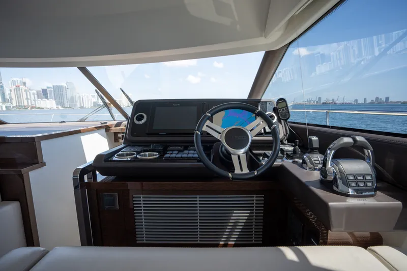 Slide: The Image of Cockpit of 2020 Prestige 520 yacht with modern controls and city skyline view. - 30