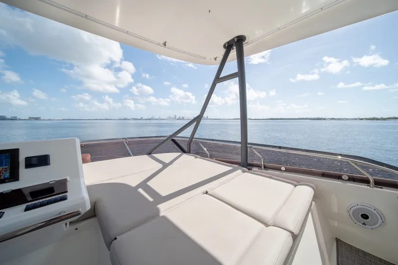 Slide: The Image of Luxurious 2020 Prestige 520 yacht deck with panoramic ocean view under a clear blue sky. - 33