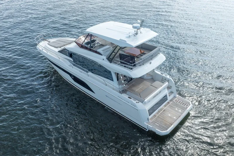 Slide: The Image of Luxury 2020 Prestige 520 yacht cruising on open water, showcasing sleek design and spacious deck. - 7