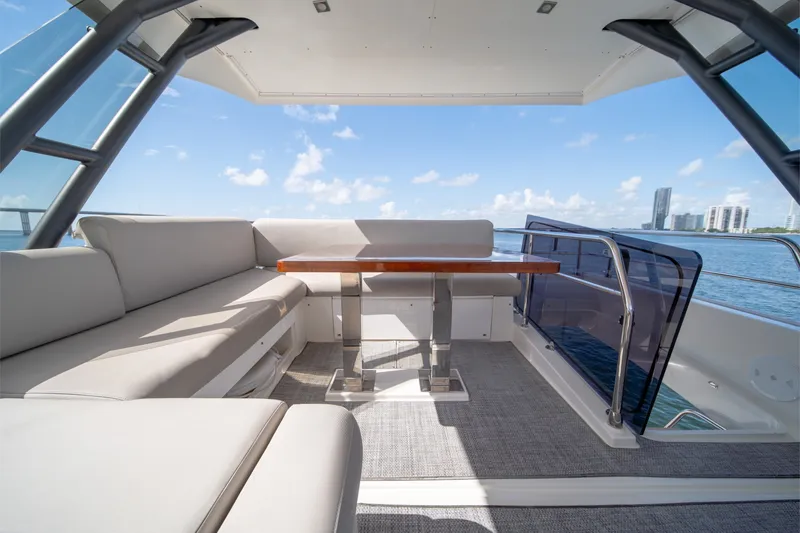 Slide: The Image of Luxurious 2020 Prestige 520 yacht deck with seating, table, and ocean view. - 28