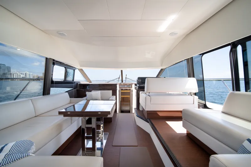 Slide: The Image of Luxurious interior of 2020 Prestige 520 yacht with elegant seating and panoramic windows. - 16