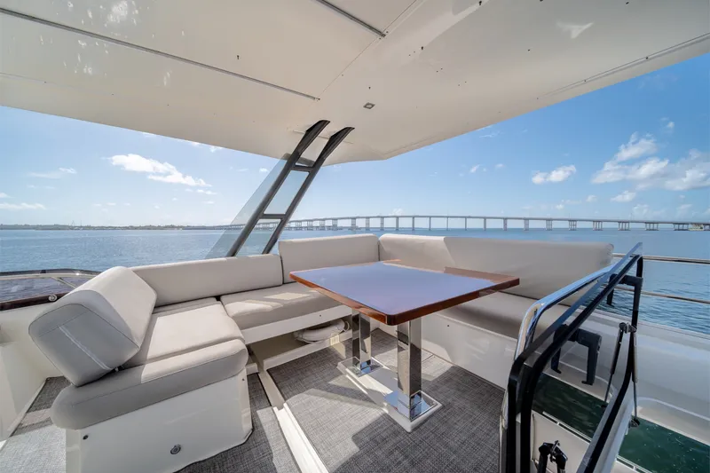 Slide: The Image of Luxurious seating area on 2020 Prestige 520 yacht with ocean view and bridge in background. - 29