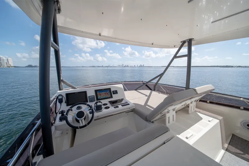 Slide: The Image of Flybridge of 2020 Prestige 520 yacht with city skyline view. - 31