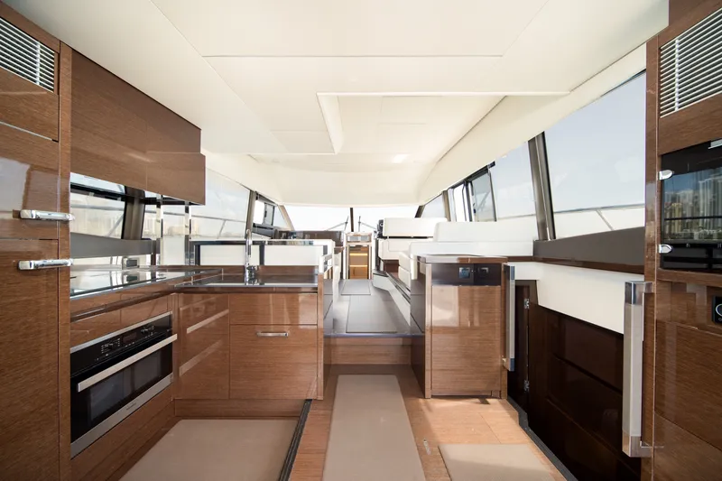 Slide: The Image of Luxurious interior of a 2020 Prestige 520 yacht with modern kitchen and seating area. - 15