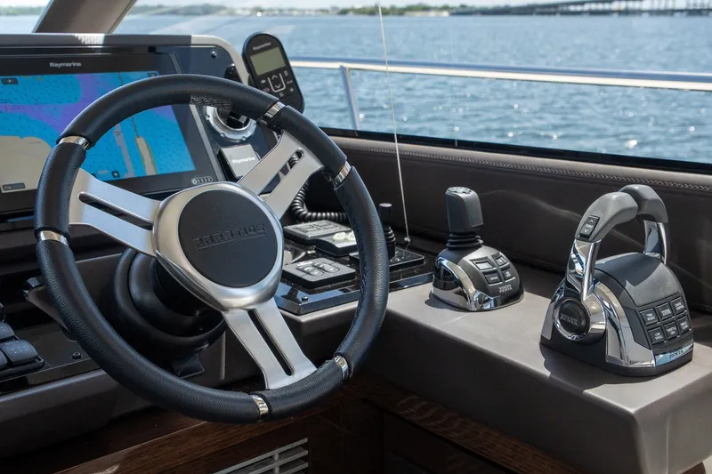 Slide: The Image of Helm of 2020 Prestige 520 yacht with navigation controls and steering wheel. - 3