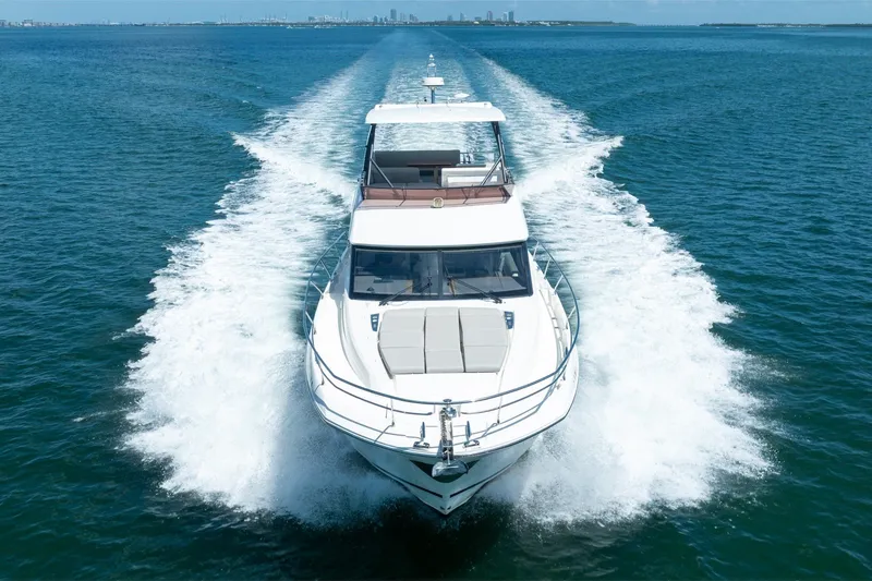 Slide: The Image of 2020 Prestige 520 yacht cruising on open blue water. - 11
