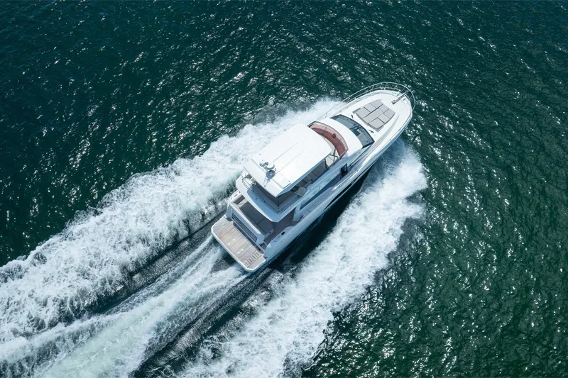Slide: The Image of Aerial view of 2020 Prestige 520 yacht cruising on open water. - 10