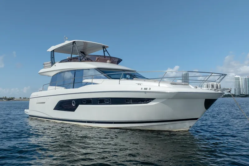 Slide: The Image of Luxury 2020 Prestige 520 yacht on calm water, clear sky background. - 5