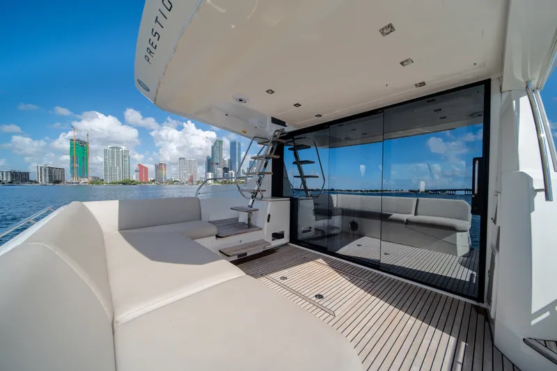 Slide: The Image of Luxurious 2020 Prestige 520 yacht deck with city skyline view and modern seating. - 13