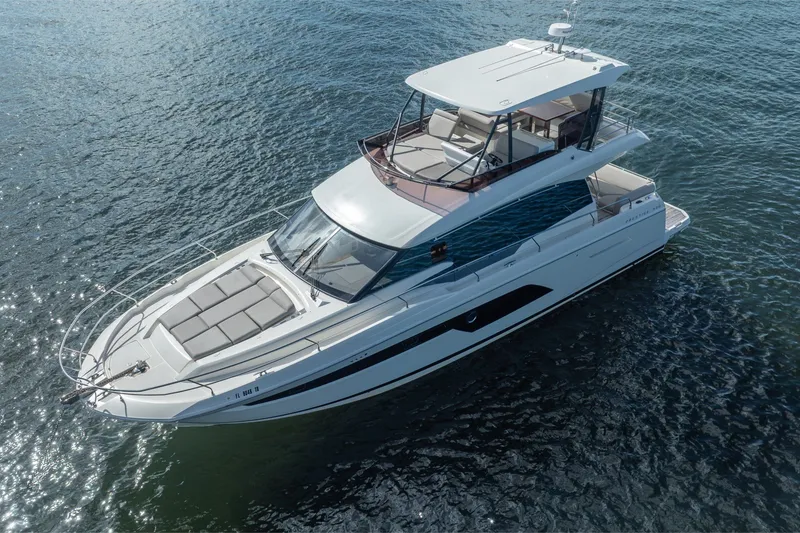 Slide: The Image of 2020 Prestige 520 yacht cruising on open water, showcasing sleek design and luxury features. - 6