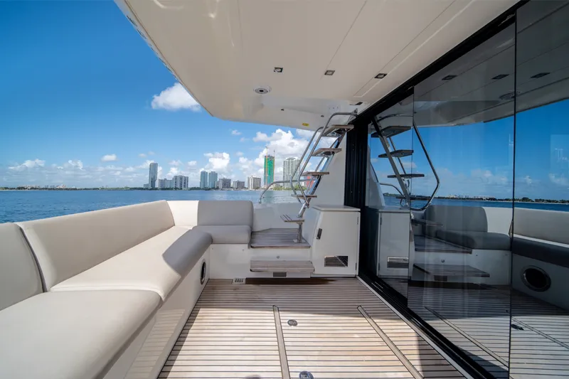 Slide: The Image of Luxurious 2020 Prestige 520 yacht deck with city skyline view, featuring sleek design and comfortable seating. - 1
