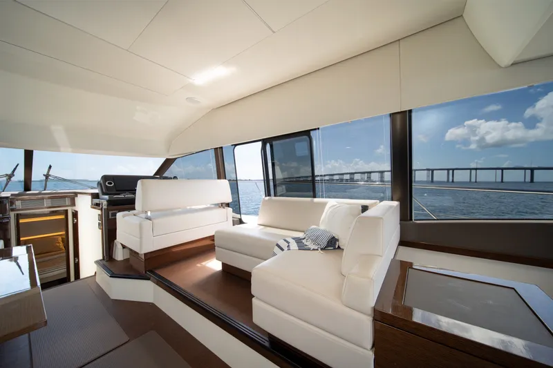 Slide: The Image of Luxurious interior of 2020 Prestige 520 yacht with elegant white seating and panoramic windows. - 17