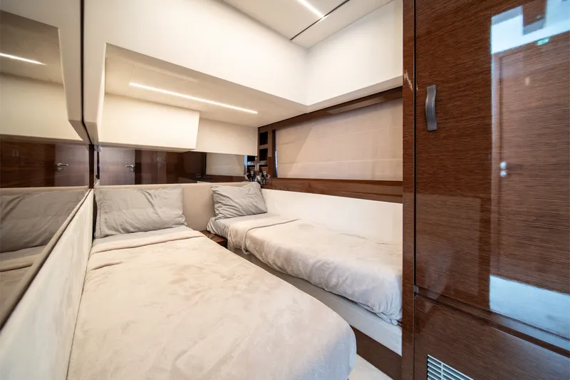 Slide: The Image of Luxurious interior of a 2020 Prestige 520 yacht cabin with modern design and cozy bedding. - 27