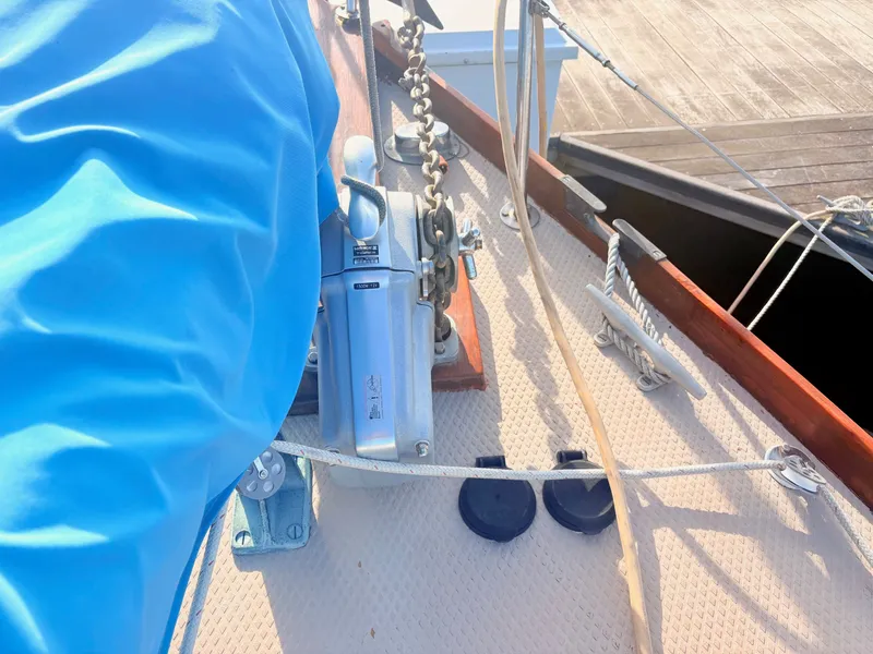 Slide: The Image of Close-up of a 1979 Shannon 38 deck with a windlass and ropes. - 11