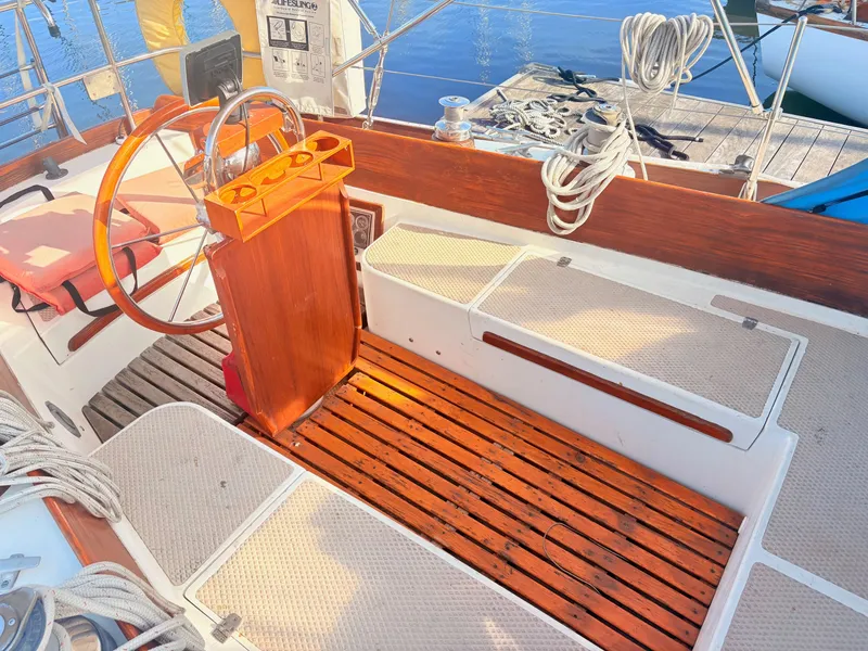 Slide: The Image of The cockpit of a 1979 Shannon 38 with wooden details and a steering wheel. - 14