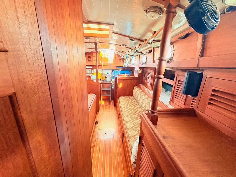 Slide: The Image of Interior of a 1979 Shannon 38 with wooden finish and cozy seating area. - 29
