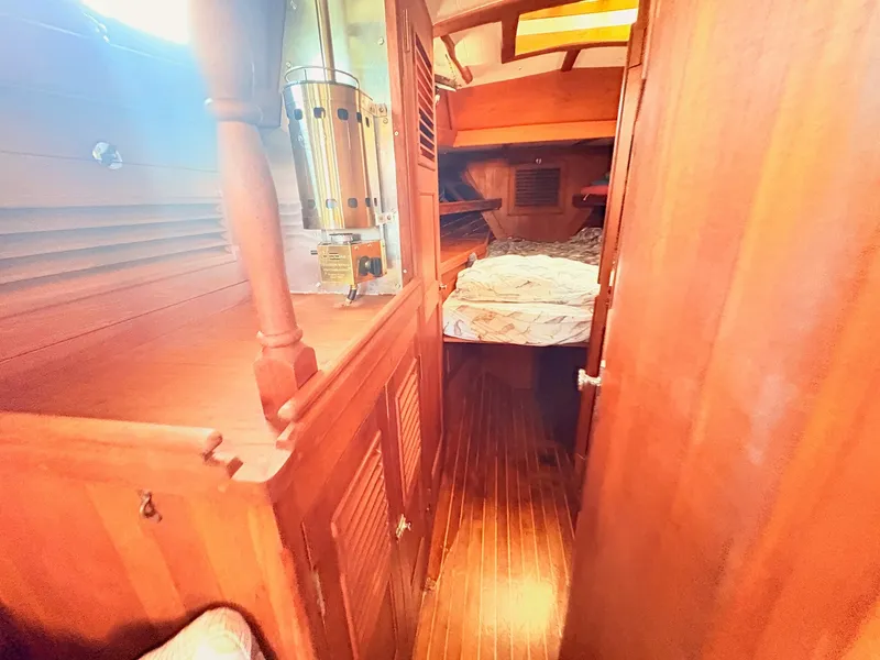 Slide: The Image of Interior of a 1979 Shannon 38 with wooden features and a cozy sleeping area. - 25