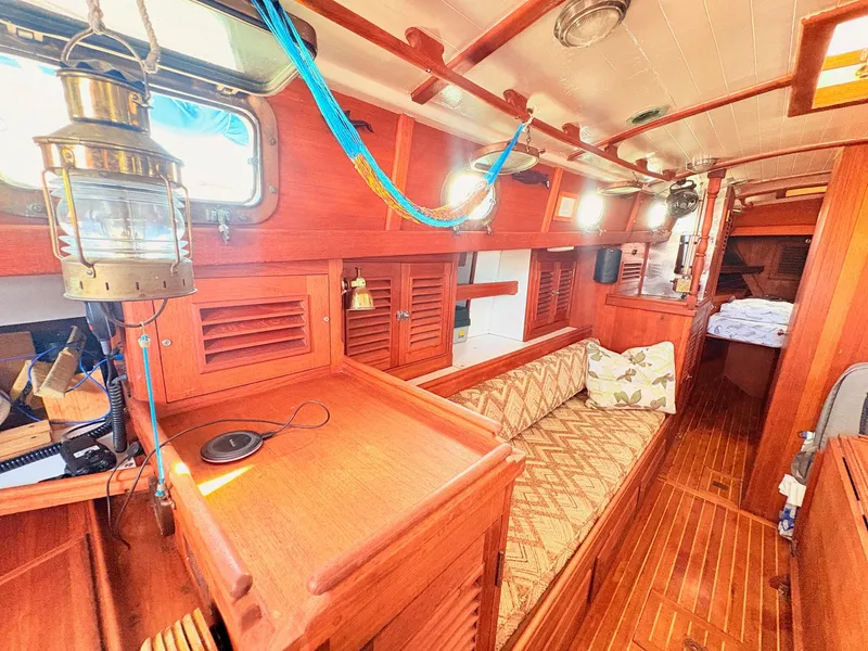 Slide: The Image of Interior of a 1979 Shannon 38 with wooden furnishings and a cozy seating area. - 21
