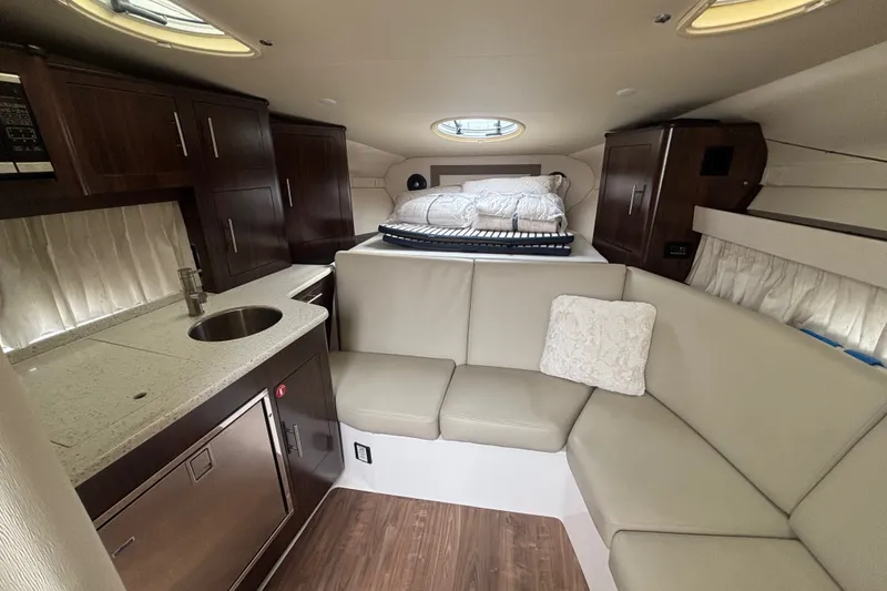 Slide: The Image of Luxurious interior of 2018 Regal 33 XO yacht with kitchenette and cozy seating area. - 24