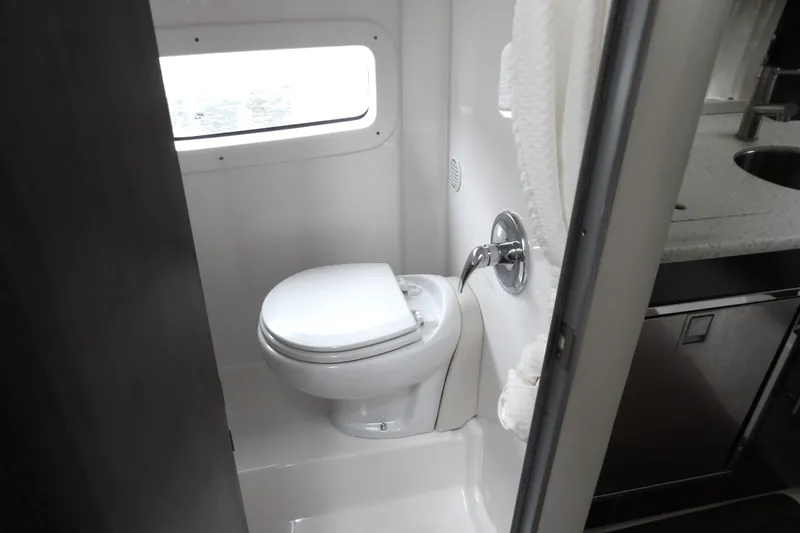 Slide: The Image of Compact bathroom in 2018 Regal 33 XO boat with toilet and window. - 34