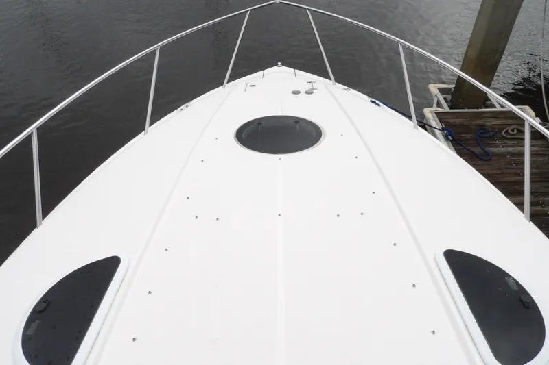 Slide: The Image of Bow view of 2018 Regal 33 XO boat docked by the water. - 21