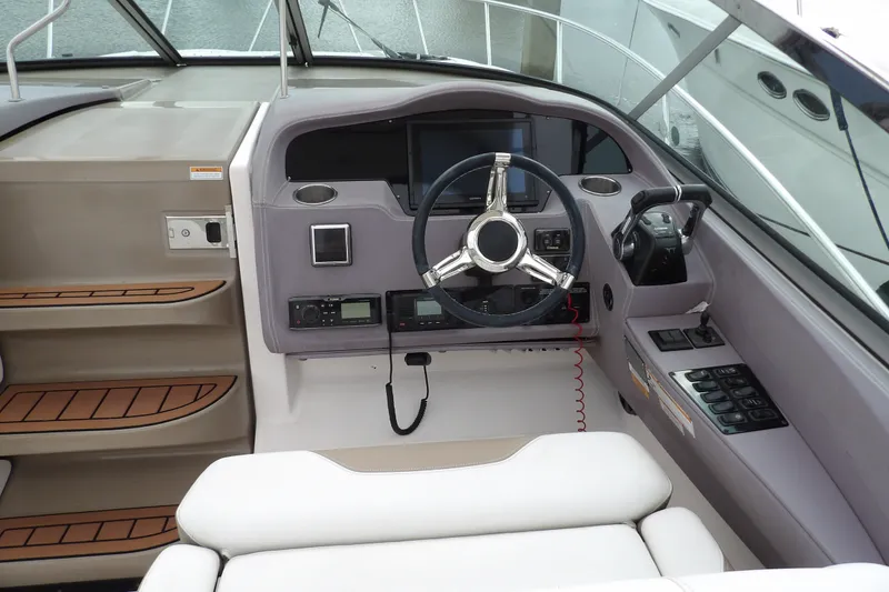 Slide: The Image of 2018 Regal 33 XO boat cockpit with modern steering and control panel. - 16