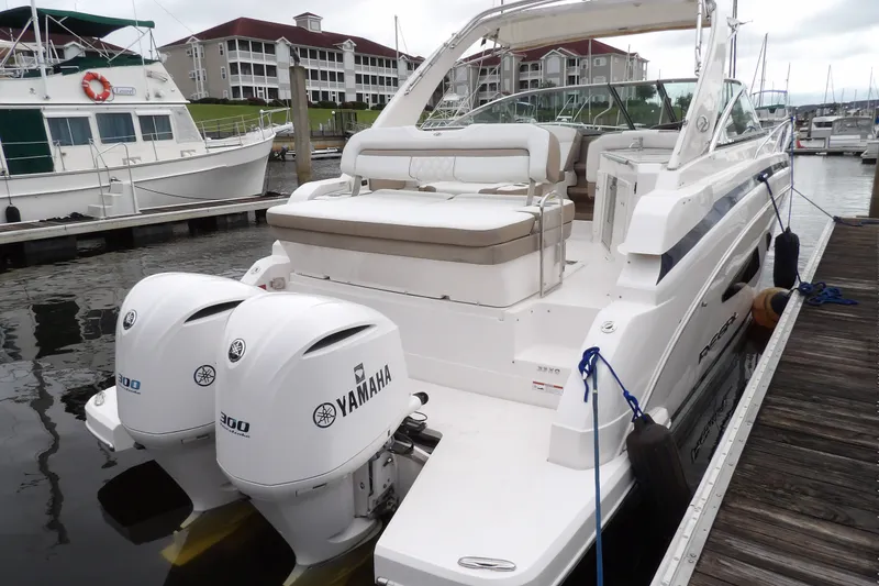 Slide: The Image of 2018 Regal 33 XO boat docked with twin Yamaha 300 engines. - 6