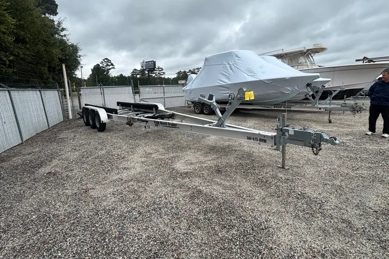 Slide: The Image of Trailer and covered 2018 Regal 33 XO boat in a gravel lot. - 39