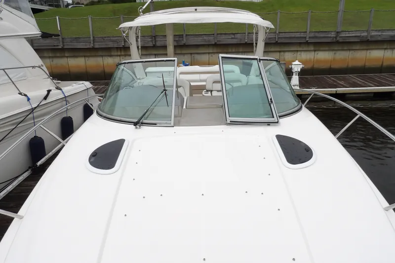 Slide: The Image of 2018 Regal 33 XO boat docked, featuring sleek design and spacious deck area. - 22