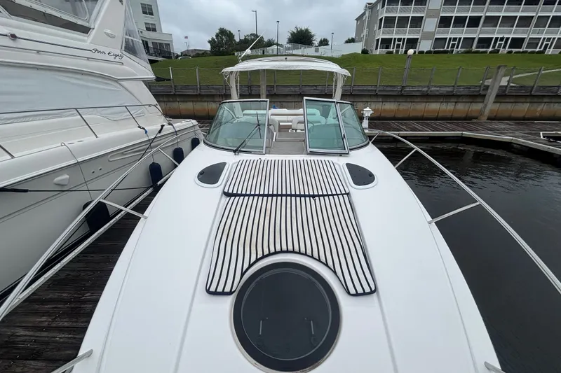 Slide: The Image of 2018 Regal 33 XO boat docked, featuring sleek design and spacious deck. - 23