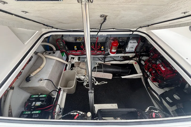 Slide: The Image of Engine compartment of a 2018 Regal 33 XO boat, featuring batteries and fire extinguisher. - 37