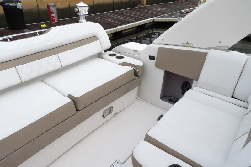 Slide: The Image of Interior seating of 2018 Regal 33 XO boat with white and beige upholstery. - 12