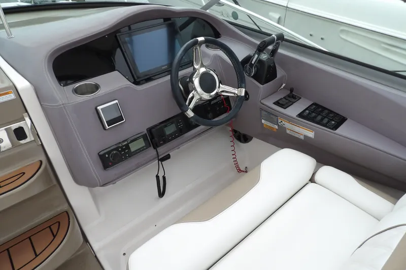 Slide: The Image of Cockpit of 2018 Regal 33 XO boat with modern steering and navigation controls. - 17