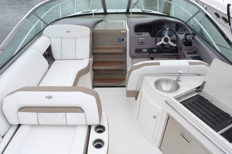 Slide: The Image of Luxurious interior of 2018 Regal 33 XO boat with seating, helm, and kitchenette. - 10