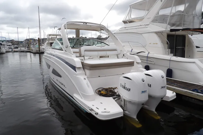 Slide: The Image of 2018 Regal 33 XO boat docked with twin Yamaha 300 engines. - 7