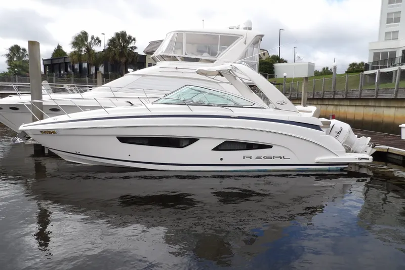 Slide: The Image of 2018 Regal 33 XO boat docked at marina, side view. - 3