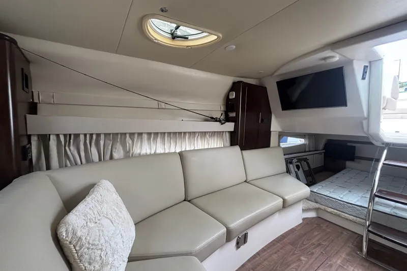 Slide: The Image of Luxurious interior of a 2018 Regal 33 XO yacht with beige seating and a mounted TV. - 29