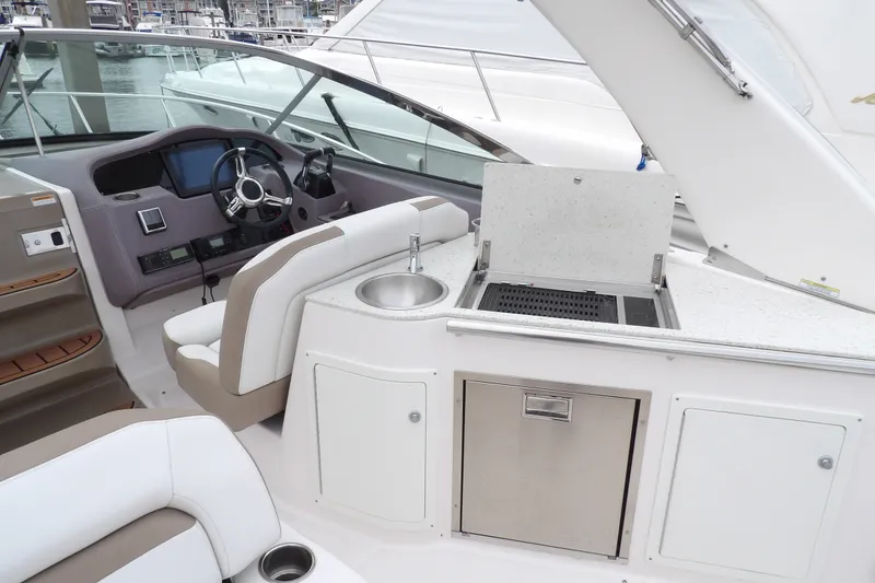 Slide: The Image of 2018 Regal 33 XO yacht cockpit with helm, sink, and grill station. - 15