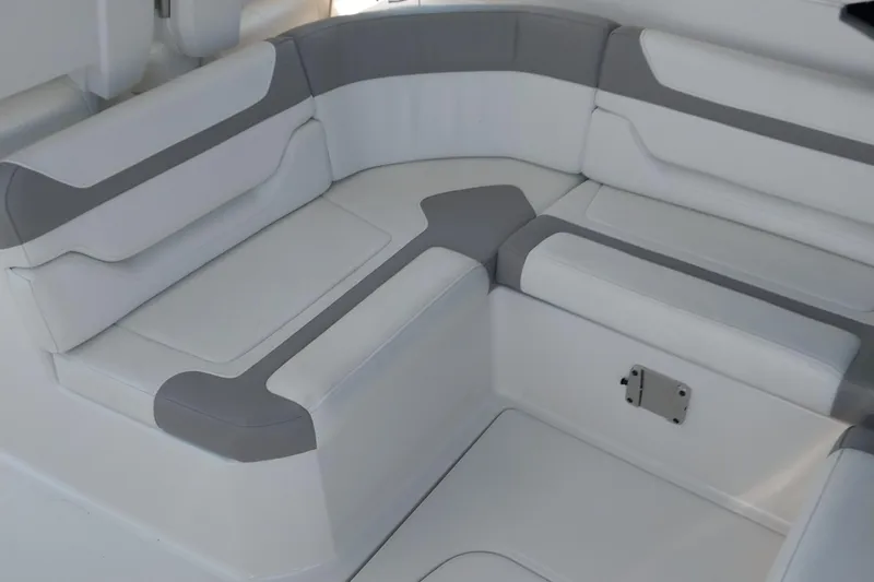 Slide: The Image of 2011 Monterey 340 Sport Yacht interior seating, featuring white and gray cushioned upholstery. - 9