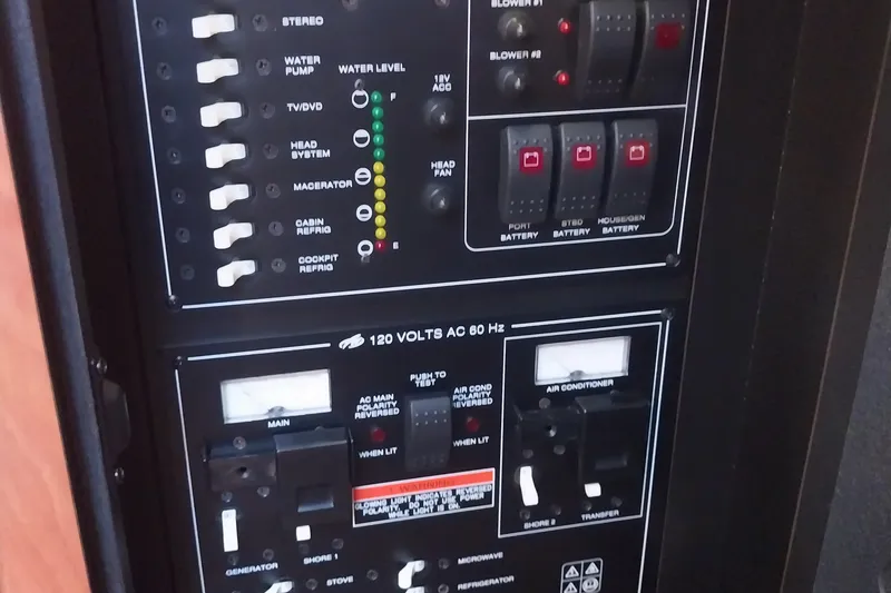 Slide: The Image of Control panel of a 2011 Monterey 340 Sport Yacht, featuring switches and indicators. - 24