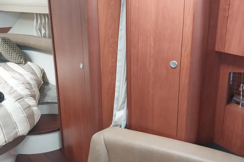 Slide: The Image of Interior of 2011 Monterey 340 Sport Yacht with wood cabinetry and cozy sleeping area. - 15