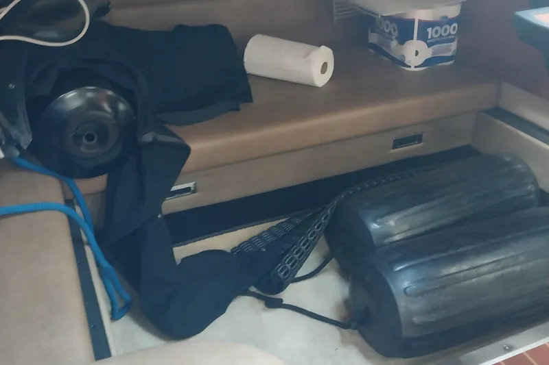 Slide: The Image of Interior of 2011 Monterey 340 Sport Yacht with fender, paper towels, and clothing. - 23
