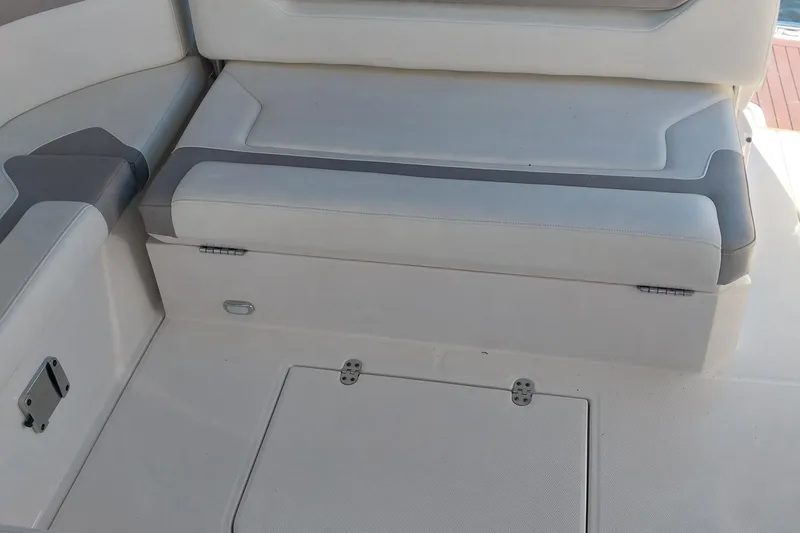Slide: The Image of 2011 Monterey 340 Sport Yacht interior seating with storage compartment. - 8