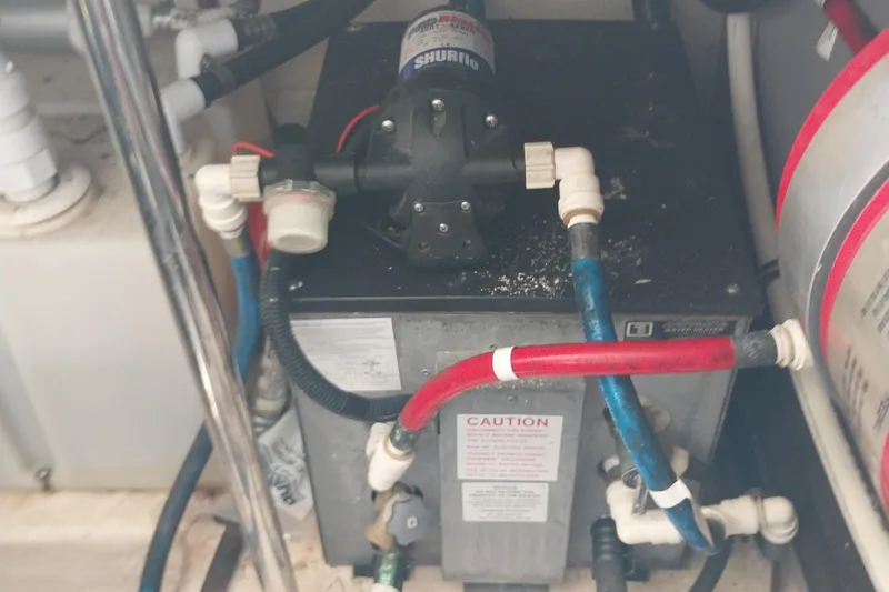 Slide: The Image of Engine compartment of 2011 Monterey 340 Sport Yacht with visible plumbing and pump system. - 32
