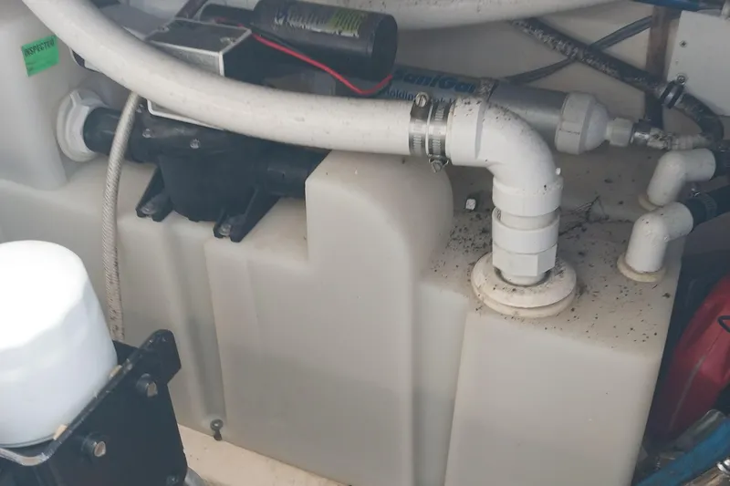 Slide: The Image of Engine compartment of a 2011 Monterey 340 Sport Yacht with visible plumbing and components. - 31