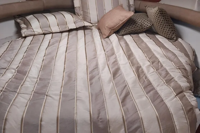 Slide: The Image of Luxurious striped bedding in a 2011 Monterey 340 Sport Yacht cabin. - 11