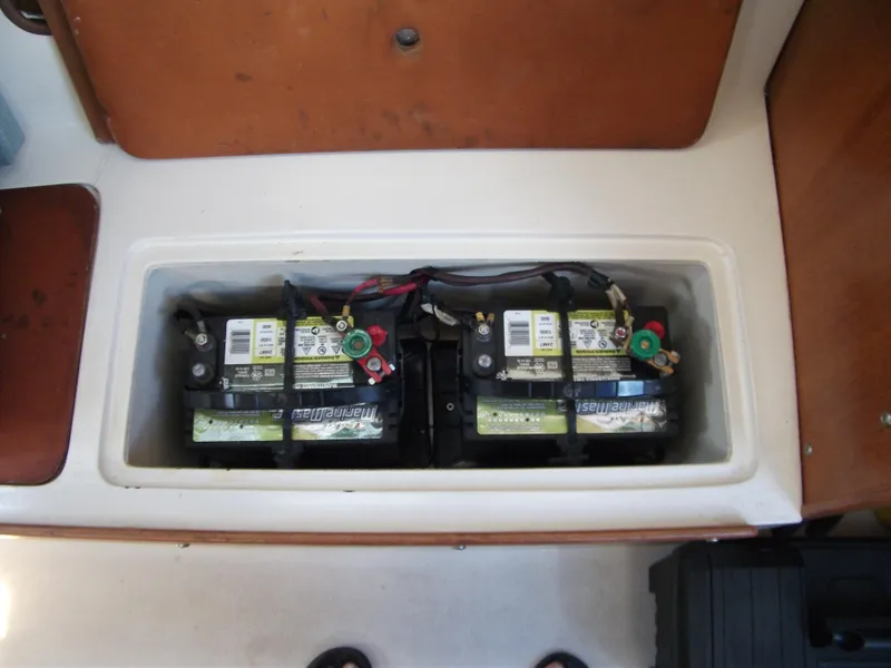 Slide: The Image of Battery compartment of a 1992 Catalina 30 MkII sailboat, featuring dual marine batteries. - 23